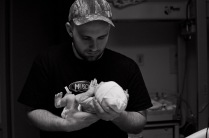 Dad holds his baby for the first time.